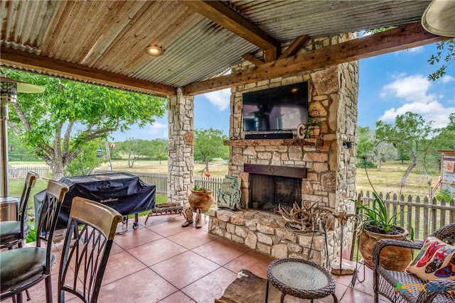 view of patio with area for grilling and an outdoor stone fireplace