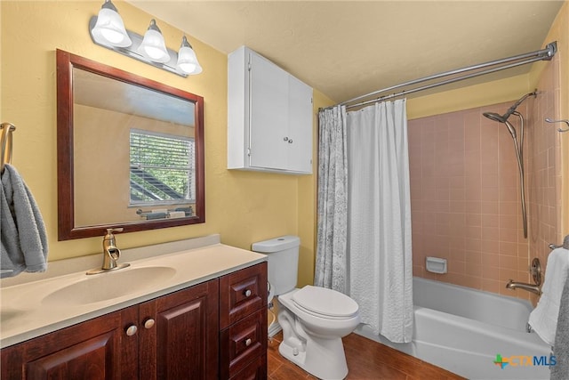 full bathroom with shower / bath combo with shower curtain, vanity, and toilet