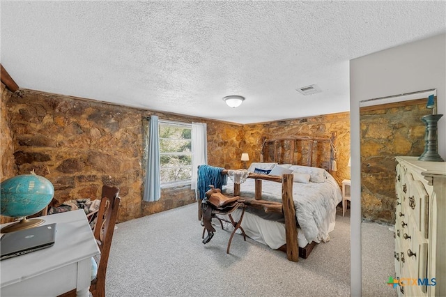 bedroom featuring carpet and a textured ceiling