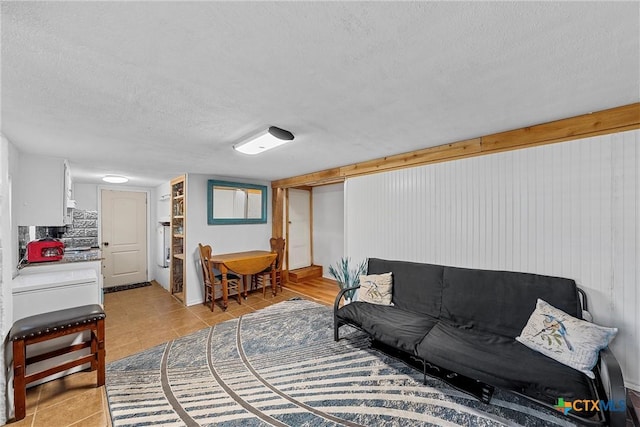 tiled living room with a textured ceiling