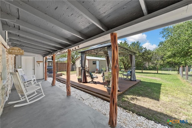 view of patio / terrace featuring a gazebo, a wooden deck, and an outdoor structure