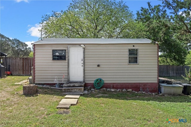 view of outbuilding featuring a yard