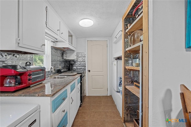 kitchen with decorative backsplash, sink, white cabinets, and a textured ceiling