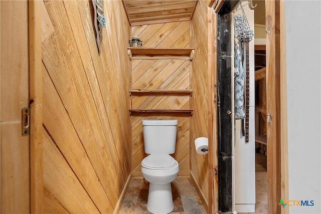 bathroom featuring wood walls, toilet, and wood ceiling