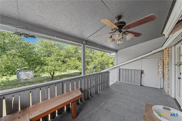 exterior space featuring ceiling fan and a balcony