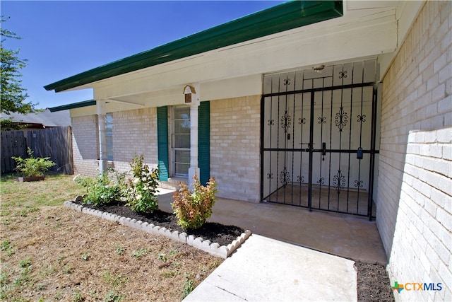 view of exterior entry featuring a porch