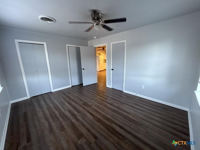 unfurnished bedroom featuring dark hardwood / wood-style floors and ceiling fan