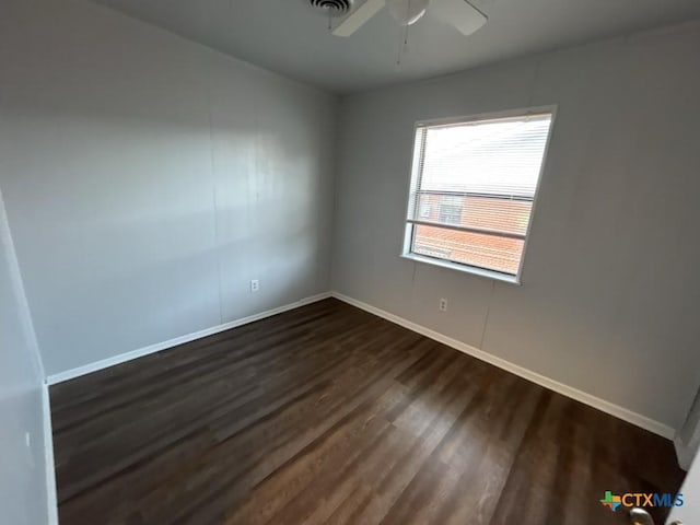 spare room with ceiling fan and dark wood-type flooring