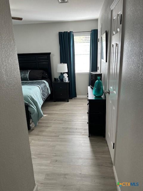 bedroom featuring wood-type flooring