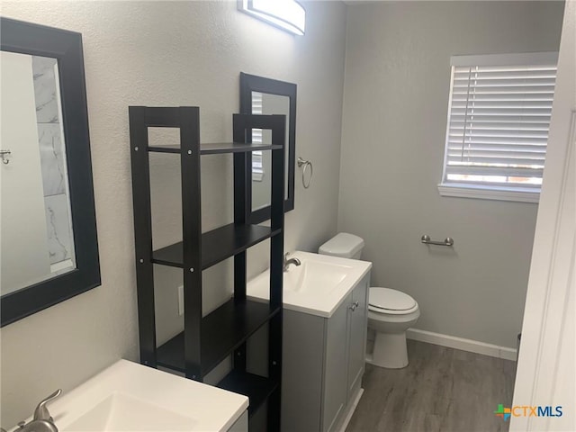 bathroom featuring vanity, hardwood / wood-style floors, and toilet