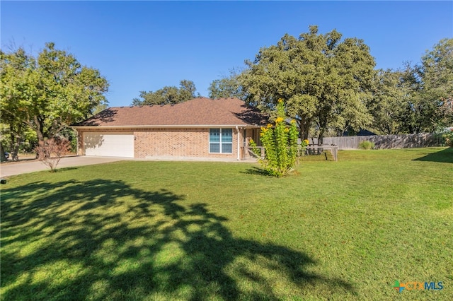 view of front of house featuring a garage and a front yard