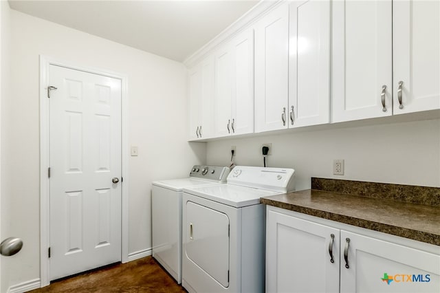 laundry area featuring cabinets and washer and clothes dryer