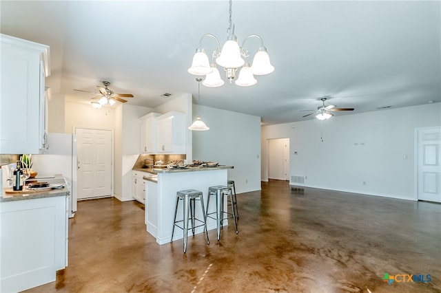 kitchen with white cabinetry, a chandelier, decorative light fixtures, and a kitchen breakfast bar