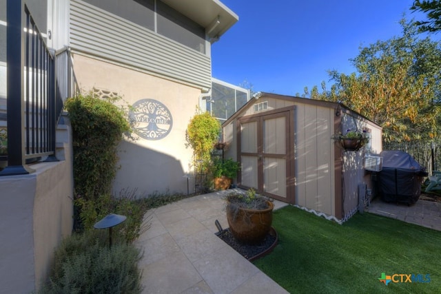 view of home's exterior featuring a storage shed, a yard, and a patio