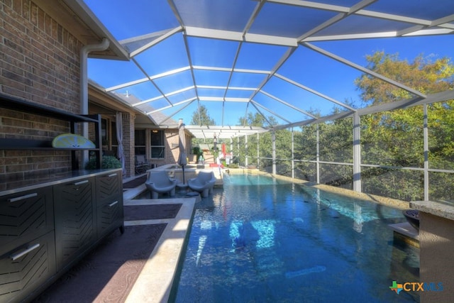 view of swimming pool featuring a lanai and a patio