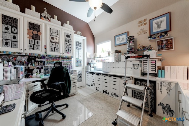 carpeted office with lofted ceiling and ceiling fan