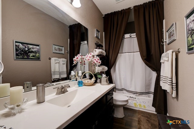 full bathroom featuring hardwood / wood-style flooring, vanity, toilet, and shower / bath combo