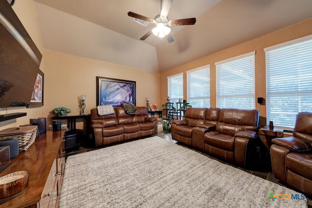 living room with plenty of natural light, ceiling fan, and vaulted ceiling