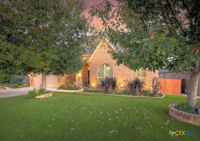 view of front of home featuring a garage and a front lawn