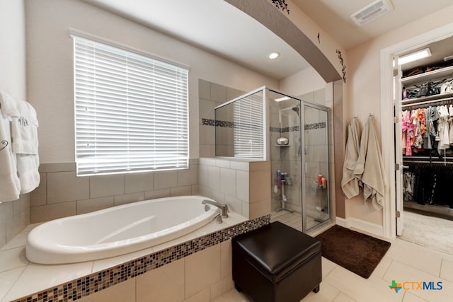 bathroom featuring tile patterned floors and shower with separate bathtub