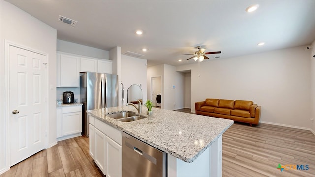 1519 Merritt St, Temple, TX 76504 - kitchen with stainless steel appliances, a sink, a ceiling fan, light wood-style flooring, and recessed lighting
