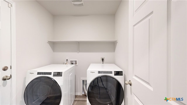 1519 Merritt St, Temple, TX 76504 - laundry room with washing machine and dryer and light wood-style flooring