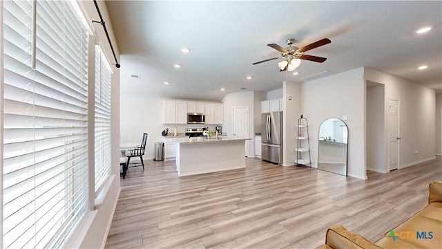 1519 Merritt St, Temple, TX 76504 - living area with ceiling fan, recessed lighting, light wood-type flooring, and baseboards