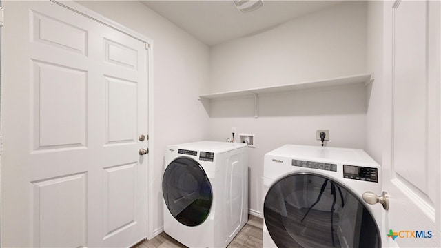 1519 Merritt St, Temple, TX 76504 - laundry area featuring washer and dryer and light wood-type flooring