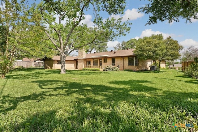 517 Cherokee Dr, Temple, TX 76504 - rear view of property with fence, a chimney, brick siding, and a yard