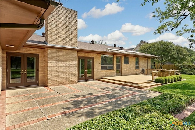 517 Cherokee Dr, Temple, TX 76504 - back of property featuring a chimney, roof with shingles, a wooden deck, french doors, and brick siding