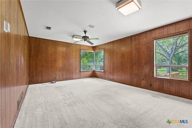 517 Cherokee Dr, Temple, TX 76504 - carpeted empty room featuring wood walls, visible vents, and ceiling fan