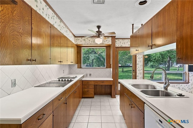 517 Cherokee Dr, Temple, TX 76504 - kitchen with wallpapered walls, a sink, black electric stovetop, and ceiling fan