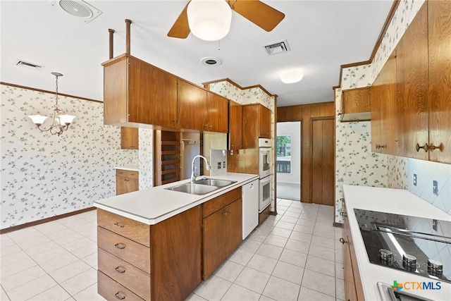 517 Cherokee Dr, Temple, TX 76504 - kitchen featuring wallpapered walls, visible vents, a sink, and brown cabinets