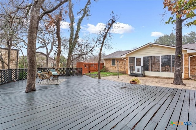 wooden deck featuring a sunroom