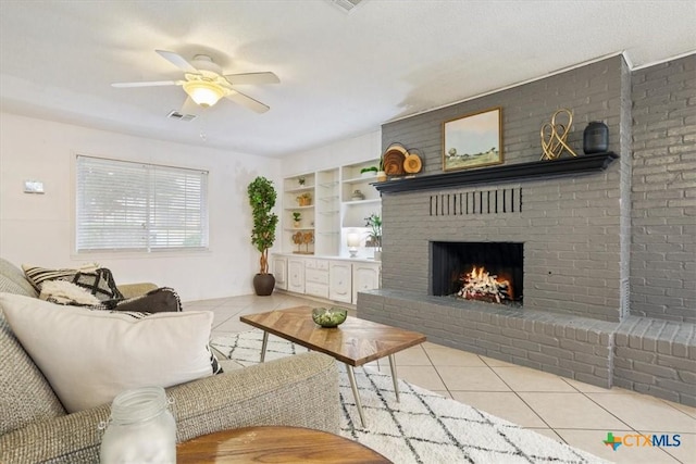 living room featuring ceiling fan, light tile patterned floors, a fireplace, and built in shelves