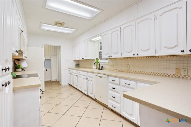 kitchen featuring tasteful backsplash, white appliances, and white cabinets