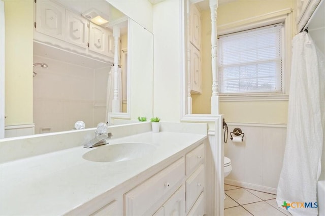 full bathroom with tile patterned flooring, vanity, shower / tub combo, and toilet