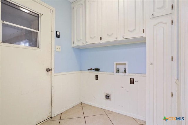 laundry area featuring light tile patterned flooring, cabinets, washer hookup, and electric dryer hookup