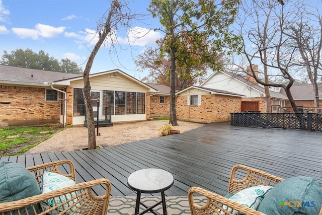 wooden deck with a sunroom