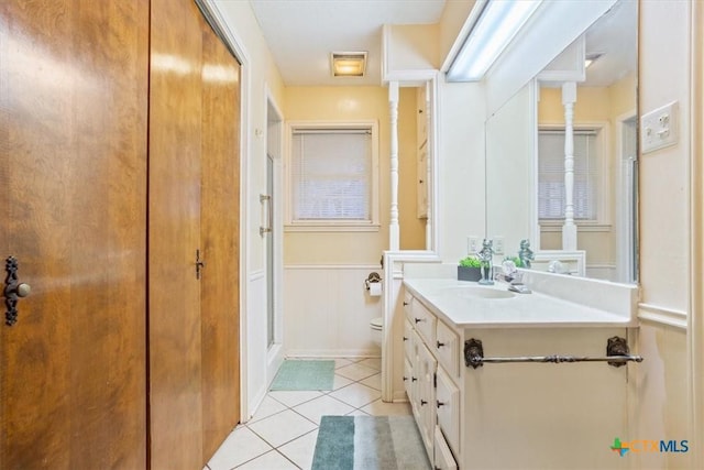 bathroom featuring tile patterned flooring, vanity, and toilet