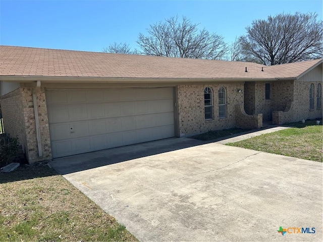 ranch-style home with an attached garage and brick siding