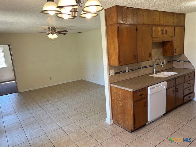 kitchen with tasteful backsplash, light tile patterned floors, ceiling fan with notable chandelier, white dishwasher, and a sink