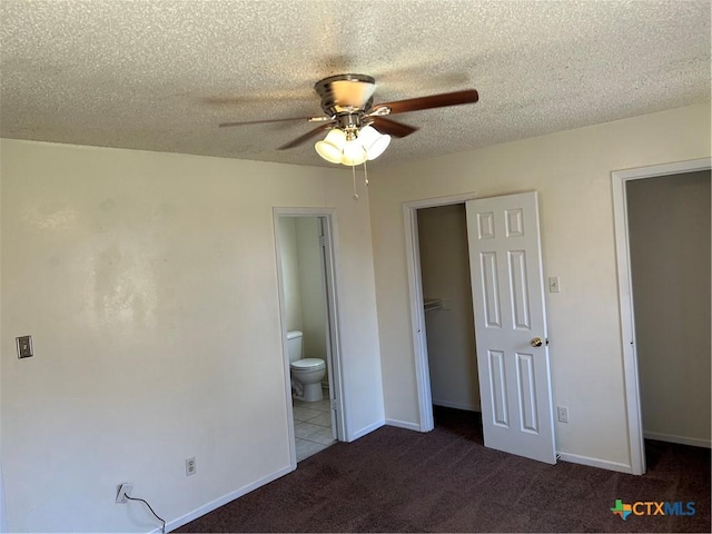 unfurnished bedroom with a closet, baseboards, a textured ceiling, and carpet flooring