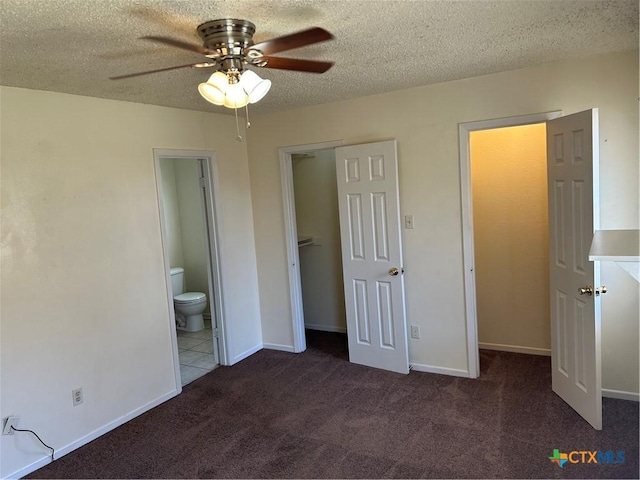 unfurnished bedroom with a closet, a textured ceiling, ensuite bathroom, and carpet