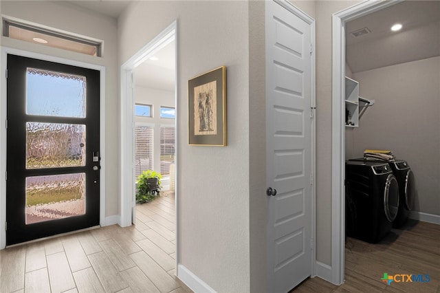 entrance foyer with washing machine and clothes dryer