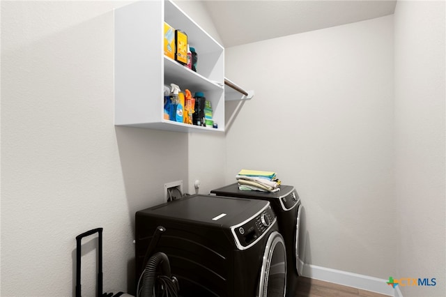 laundry room with hardwood / wood-style flooring and washing machine and clothes dryer