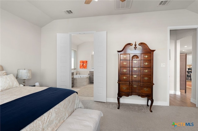 carpeted bedroom with ensuite bath, ceiling fan, and lofted ceiling