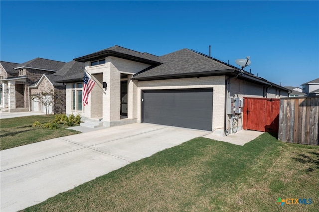 view of front of house with a garage and a front lawn