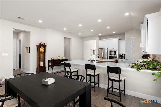 dining room with sink and dark hardwood / wood-style floors