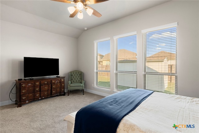 bedroom with ceiling fan, light colored carpet, and vaulted ceiling